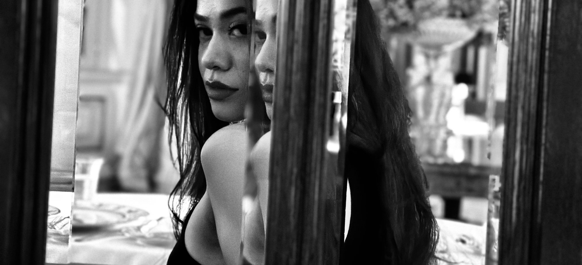 Simone reflected in a mirror, looking back over her shoulder
